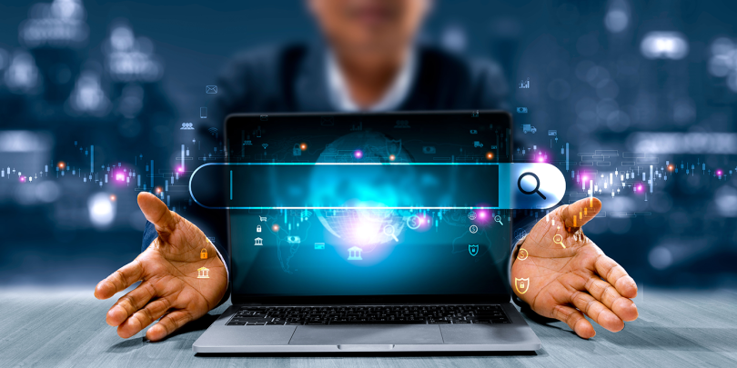 Hands-opening-laptop-search-bar